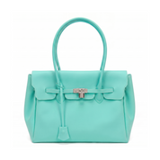 A structured turquoise leather handbag with a top handle, front flap, and silver-tone turn-lock closure, photographed on a clean white background.